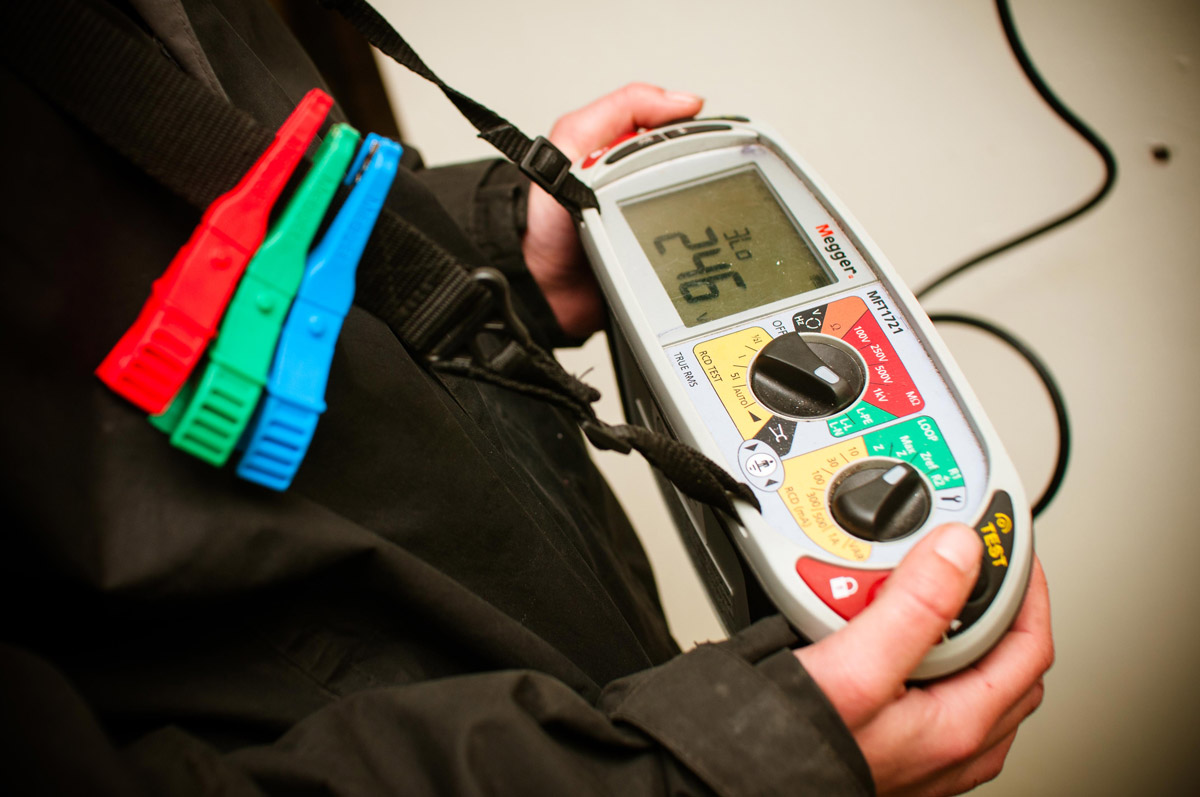 Electrician holding a testing device