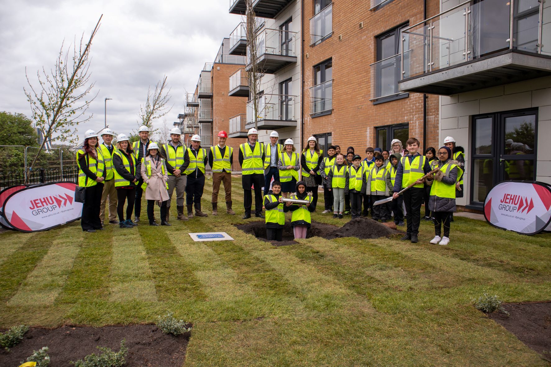 Group of people bury time capsule