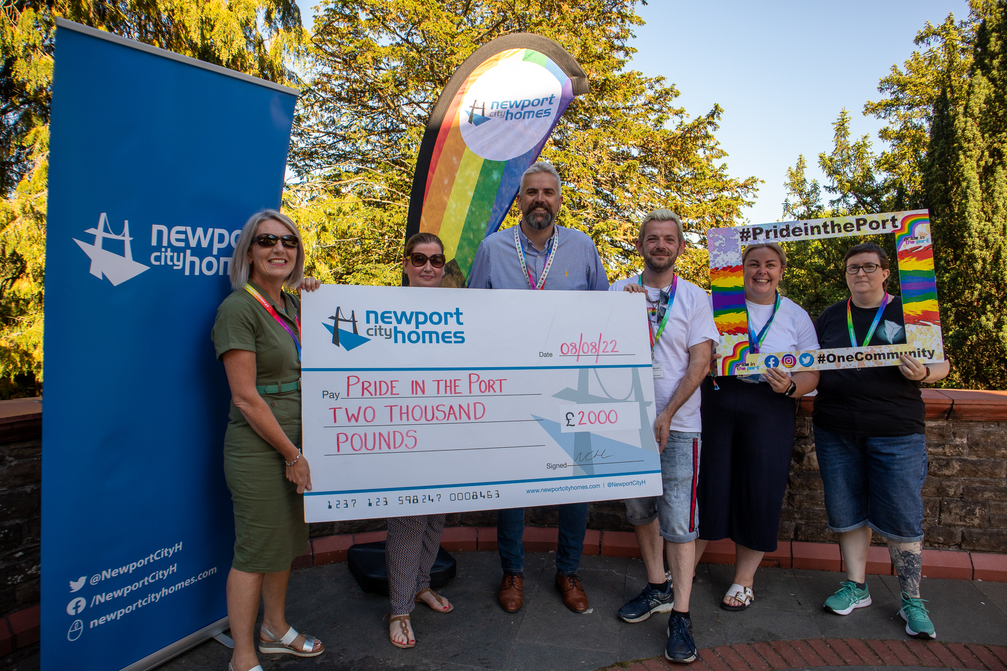 group holding a large cheque