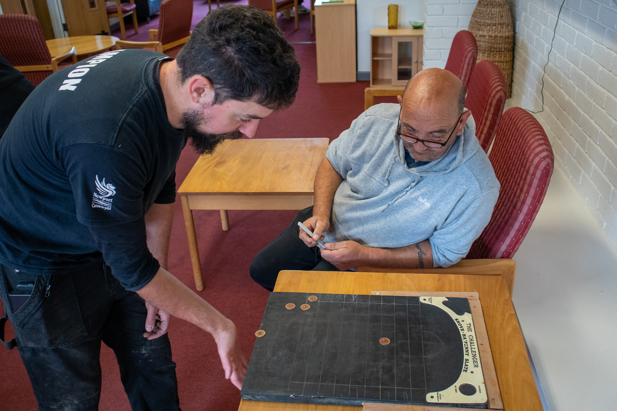 two men play shove ha'penny
