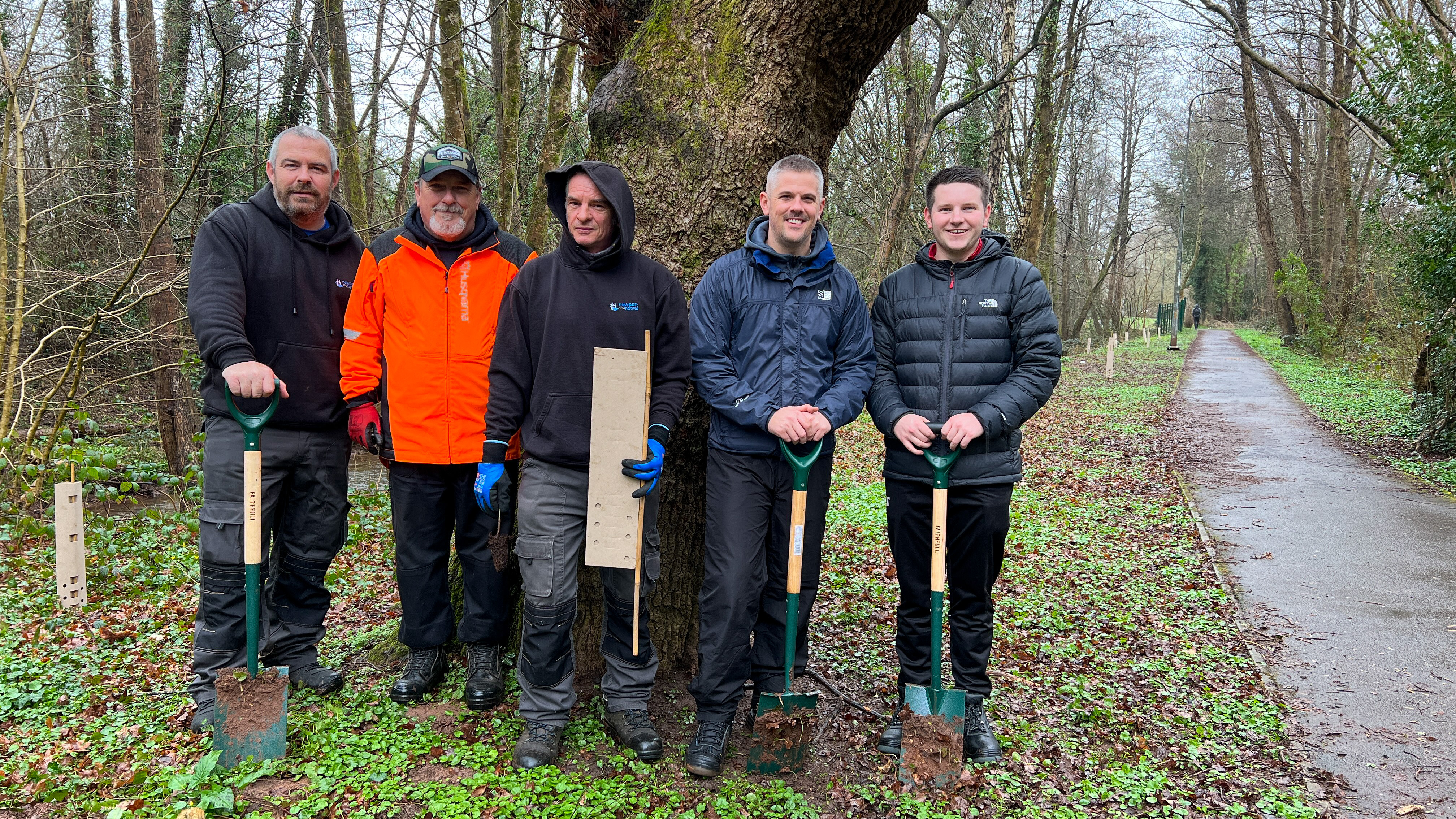 group of people stood by a tree