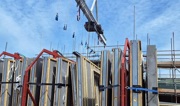 The new low-carbon building frames on site next to scaffolding